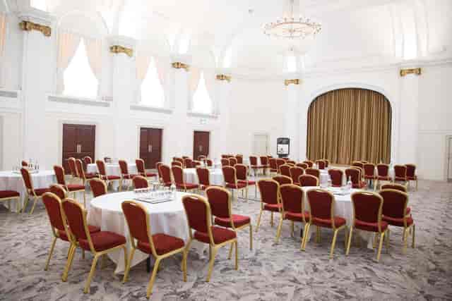 Spacious Mercure Grand Bristol ballroom with round tables, perfect for banquets and conferences.