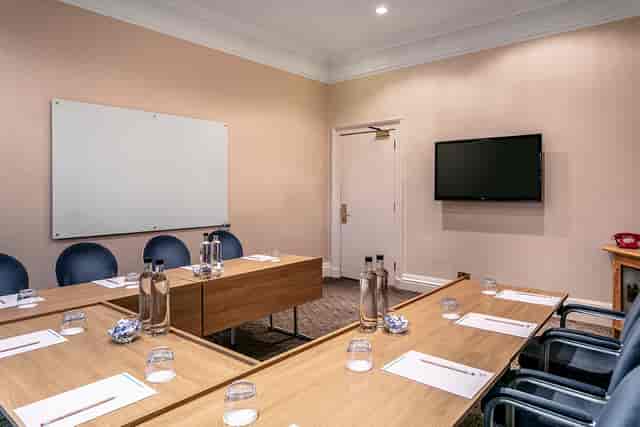 Board Room at Castle Green Hotel with central table, ideal for professional meetings.
