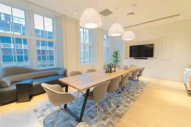 Modern meeting room at Mackintosh with large wooden table for collaborative events.