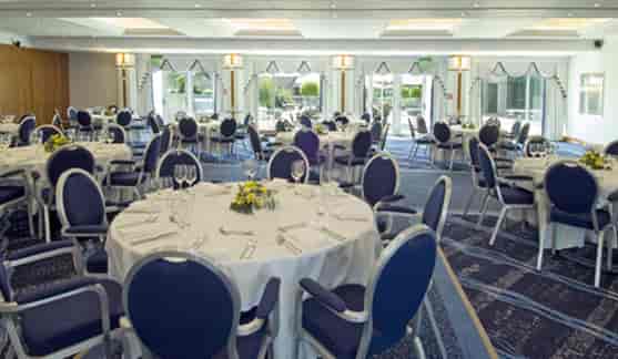 Longley Suite at Arora Hotel: elegant event space with round tables, ideal for banquets.