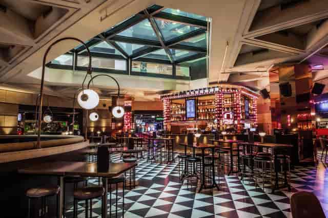 Christmas party at Puttshack with modern bar and stylish seating in vibrant event space.