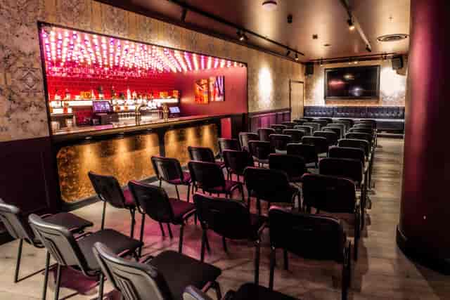 Christmas party at Puttshack Bank with sleek bar and vibrant lighting for networking events.