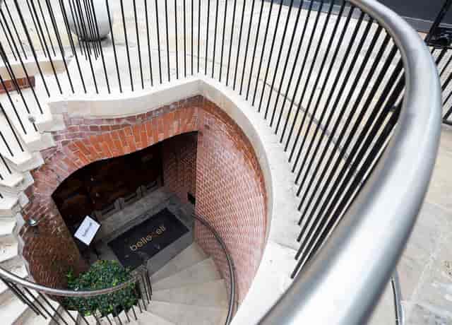 Stylish spiral staircase in BelleCell Clinic's consultation rooms for events.