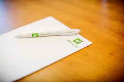 Disraeli meeting setup at Holiday Inn High Wycombe with branded stationery and pen.