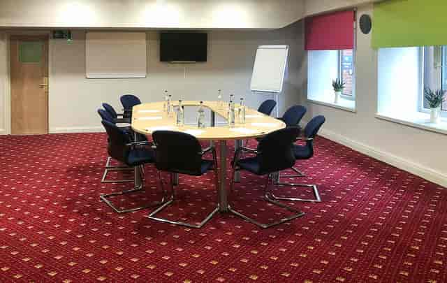 Meeting room with oval table and natural light at Ibis Styles Reading for productive events.