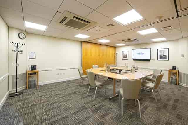 Boardroom meeting, horseshoe table, AV screen, executive event