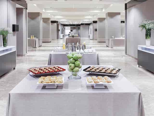 Elegant meeting space at Novotel Center with arranged tables for corporate events.