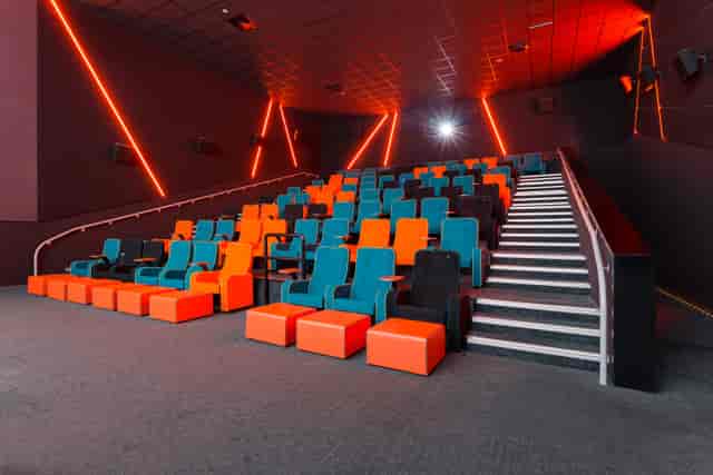 Modern cinema seating in teal and orange for engaging film screenings and presentations.