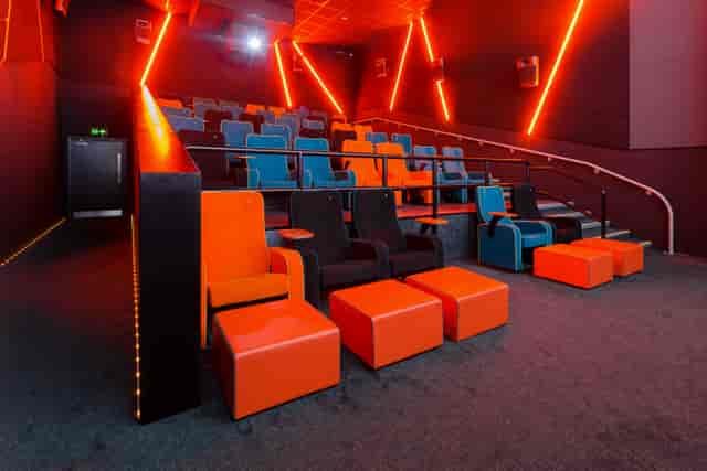Modern auditorium with vibrant orange and blue seating for events in The Light Cinema Stockport.