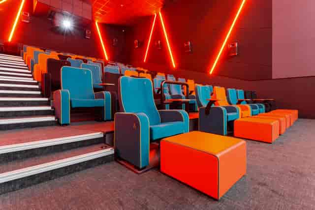 Modern auditorium with vibrant blue and orange seating for events at The Light Cinema Stockport.