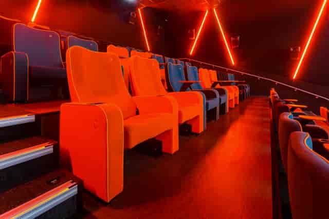 Modern theater seating in vibrant orange and blue at The Light Cinema Stockport.