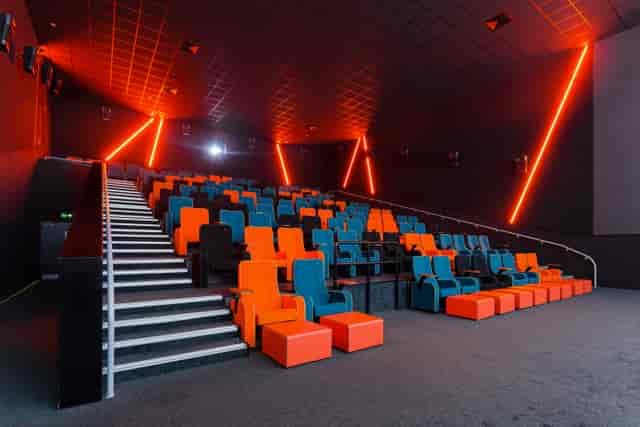 Modern auditorium with vibrant seating, ideal for screenings and corporate events.