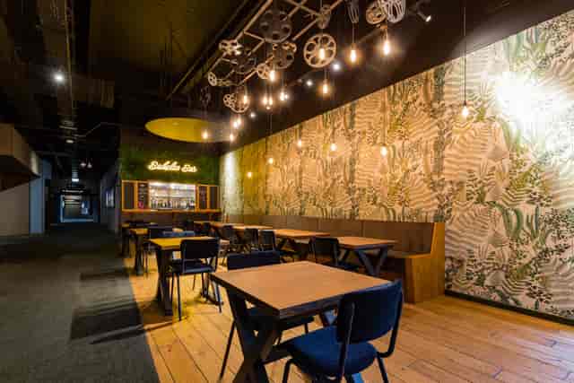 Stylish Babylon Bar event space with greenery, ideal for meetings and social gatherings.