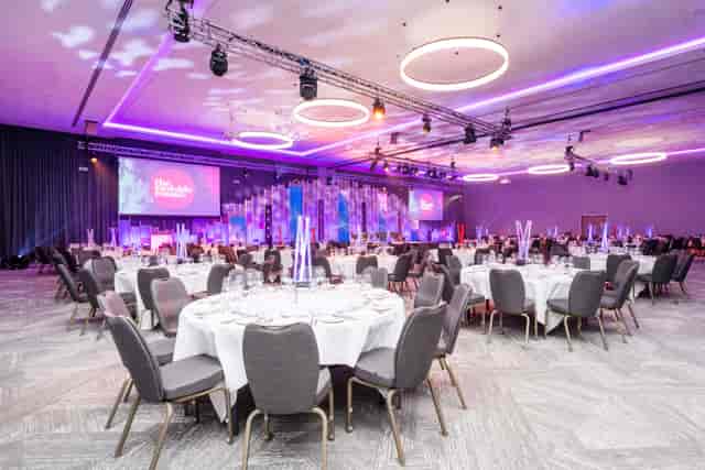 Elegant banquet hall with round tables, perfect for corporate events and gala dinners.