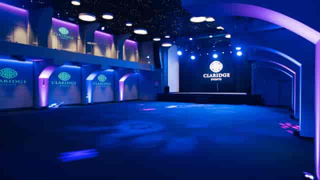 Versatile event space at Claridge with modern decor for corporate and social gatherings.