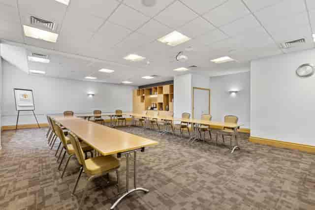 Kempe Room at St Martins House: modern meeting space with long table for workshops and presentations.