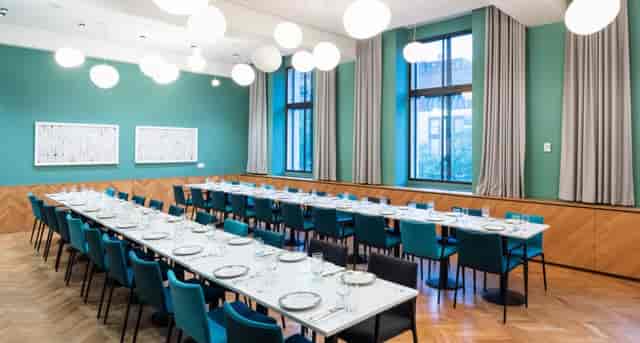 Private dining room with elegant table setup for formal events and meetings.