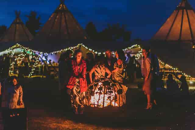 Vibrant outdoor event at Vanstone Park with illuminated tents and cozy fire pits.