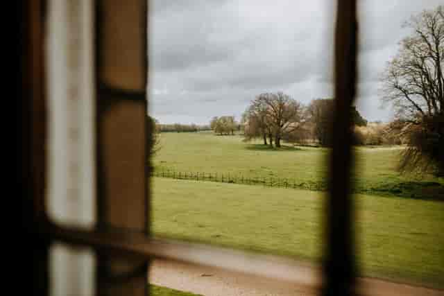 Serene Rise Hall venue with lush fields, ideal for outdoor retreats and gatherings.