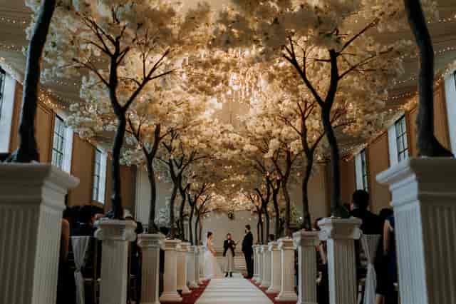 Elegant wedding ceremony space at Rise Hall with floral arrangements and white pillars.