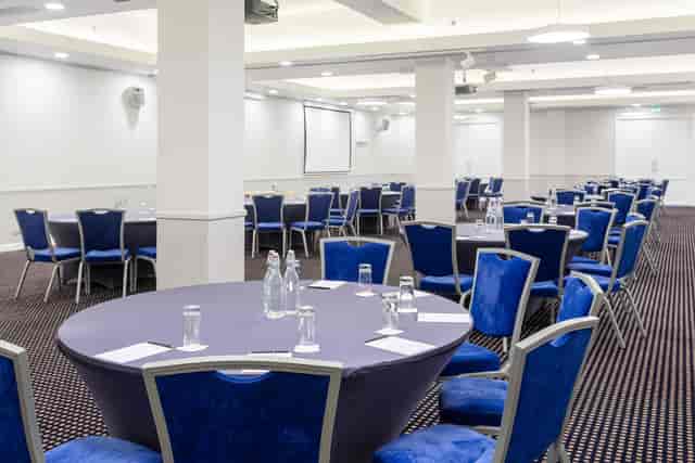 Daugava Ballroom meeting space with round tables, ideal for corporate workshops.
