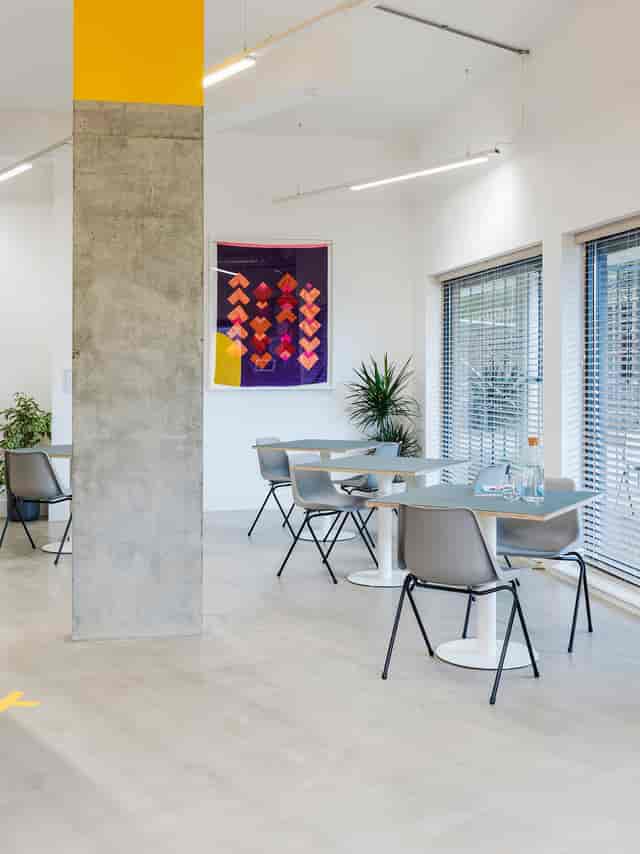 Modern meeting space in Arc Club, ideal for workshops and gatherings with vibrant decor.