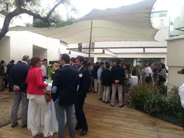 Outdoor networking event at Carob Tree Patio, Fundació Joan Miró, with high-top tables.