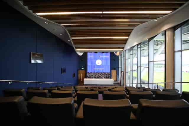 Modern event space at City Football Academy with sleek seating for corporate meetings.