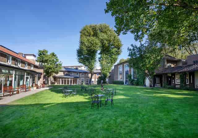 Versatile outdoor event space at St. Katharine with lush lawns and charming architecture.