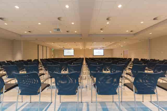 Spacious conference room with black chairs for events at Crowne Plaza Utrecht.