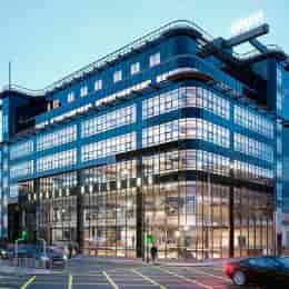 Modern glass building in Milan, perfect for corporate events and meetings.