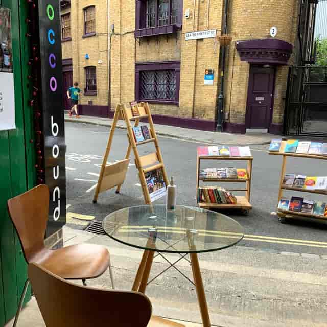 Charming outdoor meeting space with glass table at Morocco Bound Bookshop.