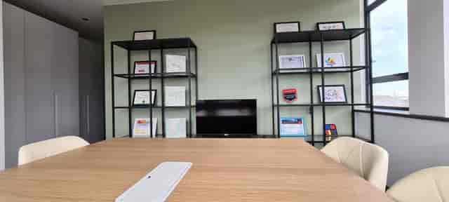 Modern Southpoint House meeting room with wooden table, ideal for corporate events and presentations.