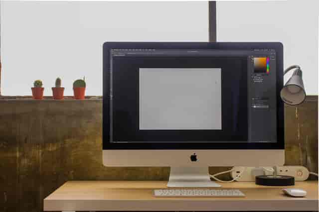 Modern event planning workspace with large monitor and minimalistic decor at Aseptic Studios.