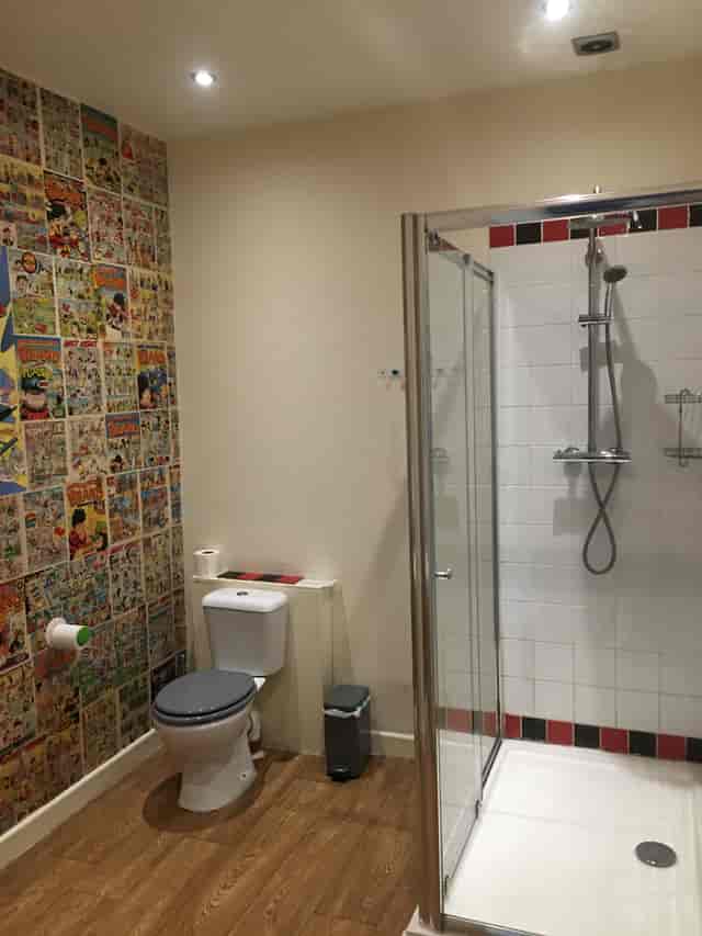 Koa tree restroom with vibrant comic book wall for memorable event experiences.