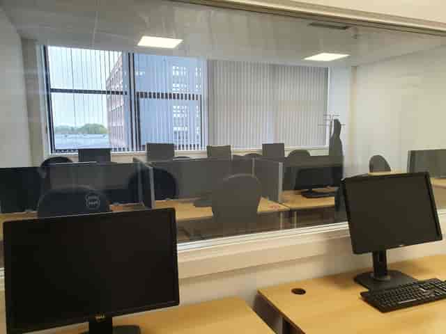 Modern training room with desks and computers, perfect for collaborative sessions.