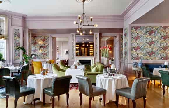 Elegant dining space in The Kensington's White Room, perfect for upscale events and gatherings.