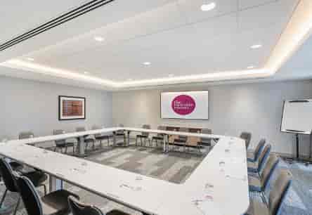 Meeting Room Six with U-shaped table, ideal for workshops and strategy sessions.
