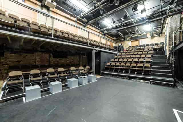 Versatile performance space with tiered seating at Arcola Theatre & Bar for events.