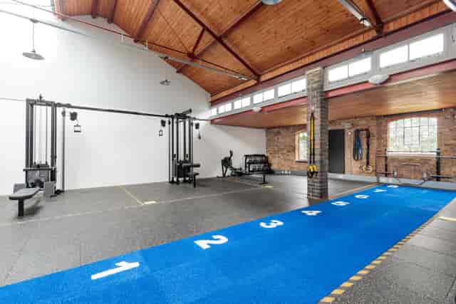 Versatile fitness venue with workout stations for corporate wellness events and team-building.