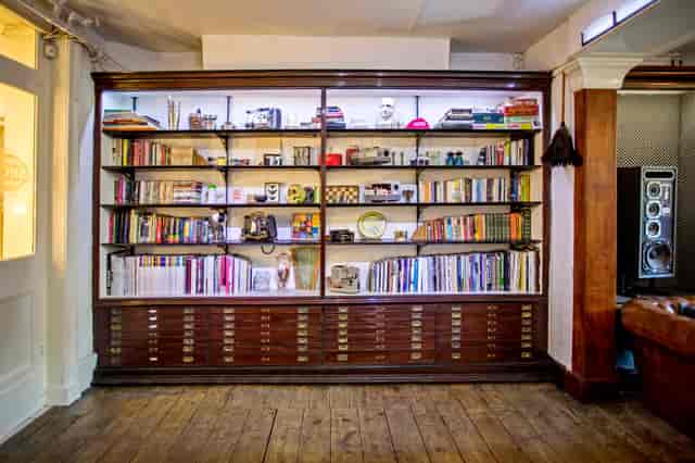 "Inviting bookshelf backdrop for meetings and events in Anomalous Space."