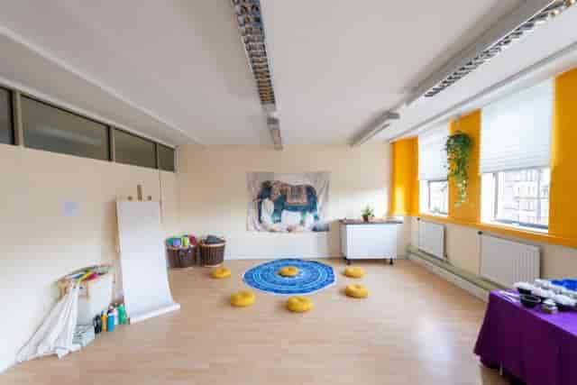 Versatile meeting space with cushions for workshops and events at St. Margaret's House.