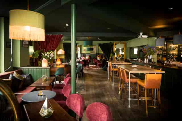 Stylish event venue with warm lighting, ideal for meetings and creative workshops.