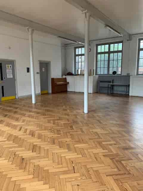 Spacious Lower Hall in Hargrave Hall with polished wood floors, ideal for workshops and gatherings.