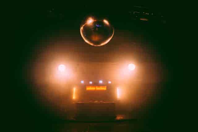 Dynamic event space with DJ booth, disco ball, ideal for nightlife and parties.