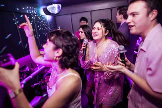 Private karaoke pods at Lucky Voice Islington, vibrant group enjoying team bonding event.