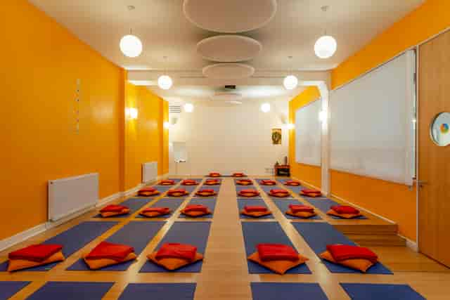 Serene yoga studio with orange walls, ideal for wellness retreats and mindfulness workshops.