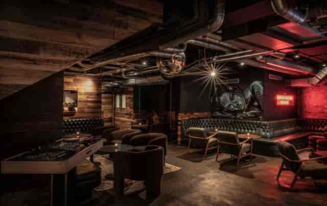 Stylish private bar with cozy seating, ideal for networking events and cocktail receptions.