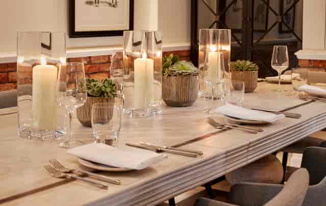 Elegant dining table with candlelight at Holmes Hotel London for intimate events.