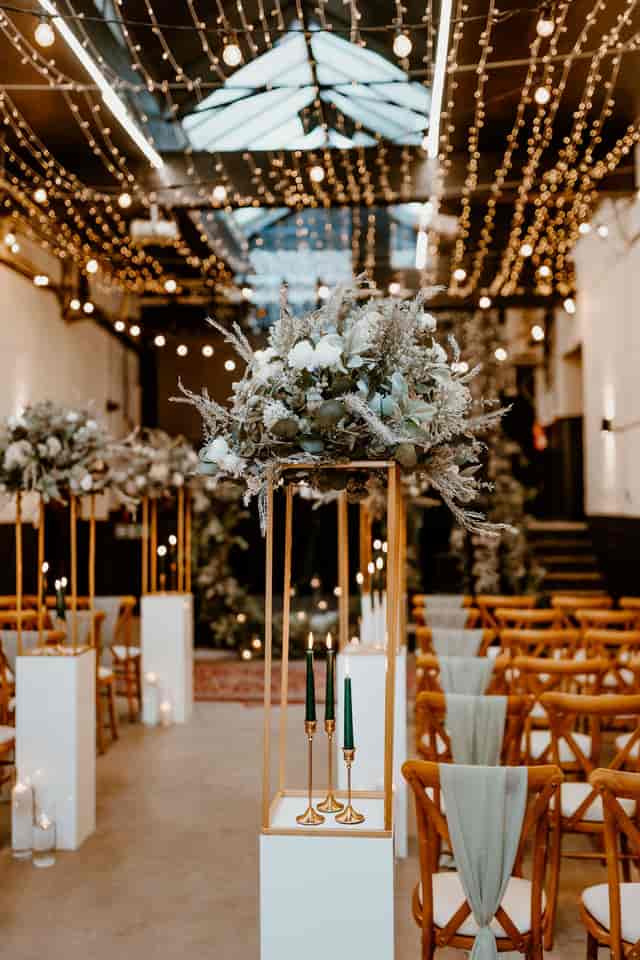 Elegant wedding event space with floral centerpieces and warm ambient lighting.